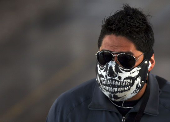 Swine flu face masks: A man wears a painted face mask in Mexico City