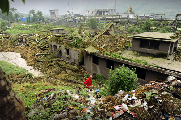 24 hours in pictures: A man outside his home destroyed in last year's Sichuan earthquake