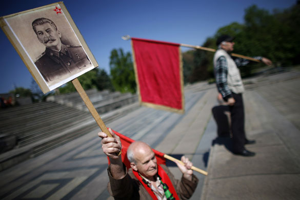 24 hours in pictures: Sofia, Bulgaria: A man holds a portrait of Soviet dictator Josef Stalin
