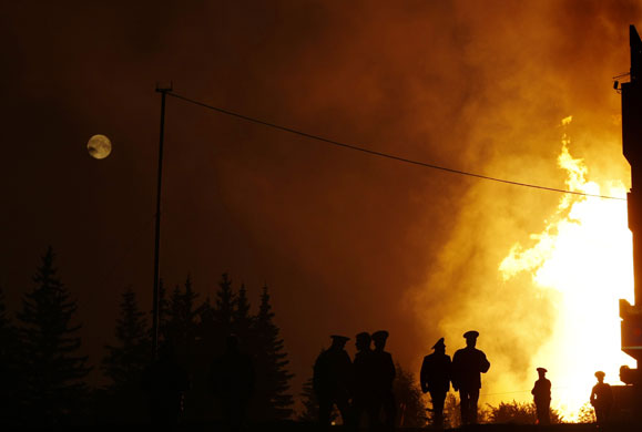 24 hours in pictures: Flames are seen in a Moscow street after a gas pipeline exploded