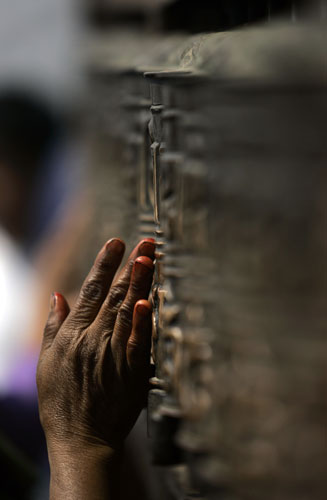 24 hours in pictures: Katmandu, Nepal: A Buddhist rotates prayer wheels 