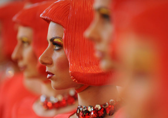 24 hours in pictures: Johannisberg castle, Germany: Performance artists wearing red plastic wigs