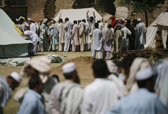 Pakistan Swat exodus: Pakistani men line up to register at a refugee camp at Swabi, Pakistan