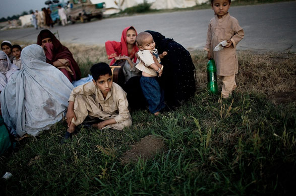 24 hours in pictures: Refugees Flee Fighting in North West Frontier Province