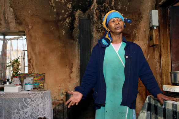 Tesco fruit farms: A disabled woman stands in farm workers' accommodation at Ceres fruit farm