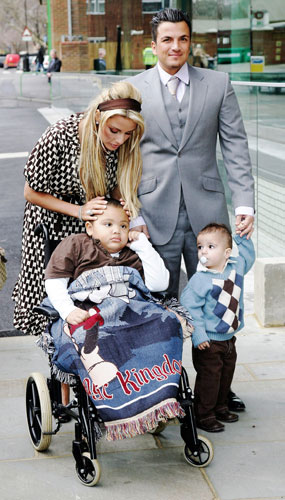 Katie and Peter: Katie Price and Peter Andre with their children at Moorfields Eye Hospital