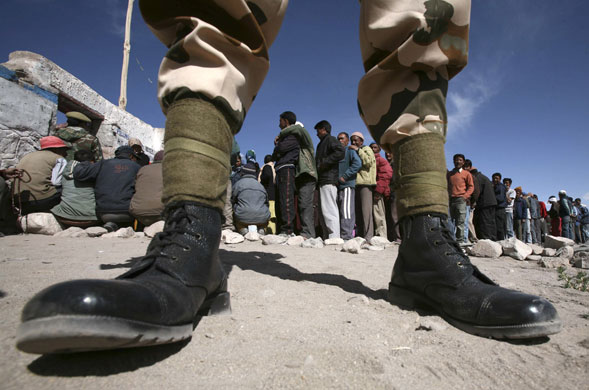 24 hours in pictures: Indian policeman keeps guard as voters line up to cast their ballots 