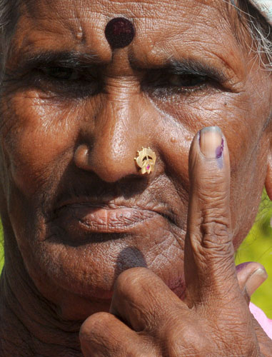 India Elections 5th Stage: Indian voter shows her ink-marked finger after voting in Indian elections