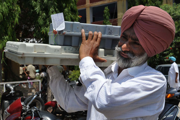 India Elections 5th Stage: An Indian Election official carries voting machines to a village