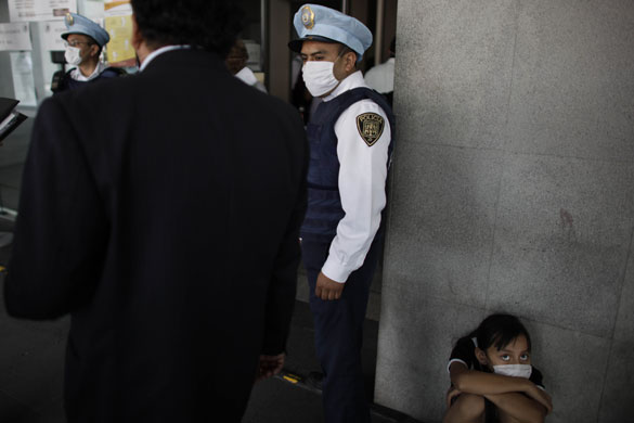 14 May 2009: Mexico City: A girl, wearing a face mask as a precaution against swine flu