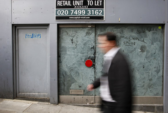 Week in business: A man walks past a closed shop in central London
