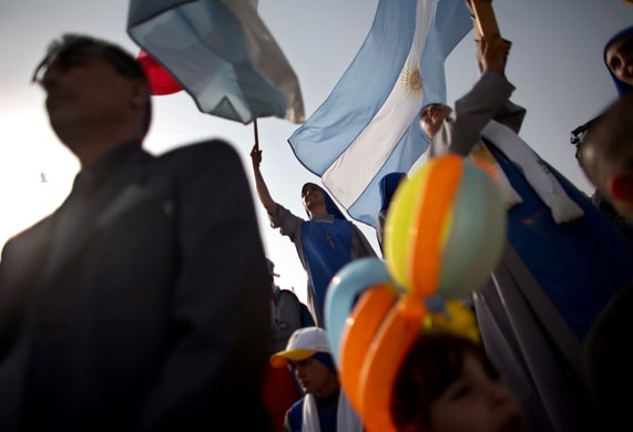 Pope Benedict: A nun waves and Argentinian flag