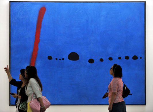 15 May 2009: Taipei, Taiwan: Visitors admire an Yves Oppenheim oil painting