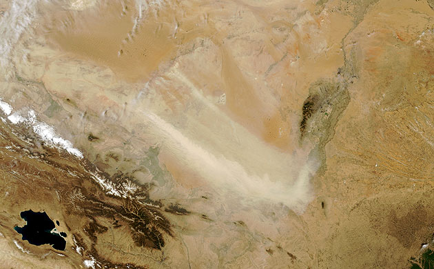 Minqin China: Tan plumes of dust swept across the Tengger Desert 