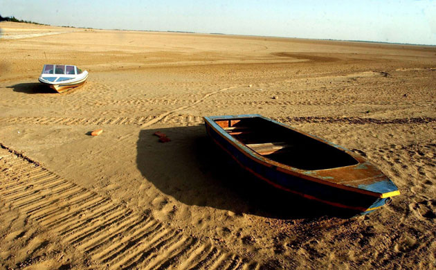 Minqin China: Boats rest on the bottom of a dried reservior oasis in China