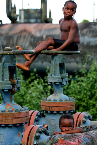 Shell in the Niger Delta: Children play on an abandoned Shell flowstation in Nigeria.