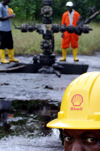 Shell in the Niger Delta: A Nigerian Shell worker watches over a spillage of crude oil near Oloibiri 
