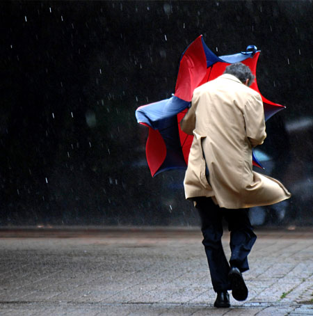 20 May 2009: Jacksonville, UK: A man and his umbrella battle the wind and rain