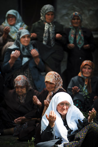 20 May 2009: Dzhebel, Bulgaria: Women pray in front of a mosque