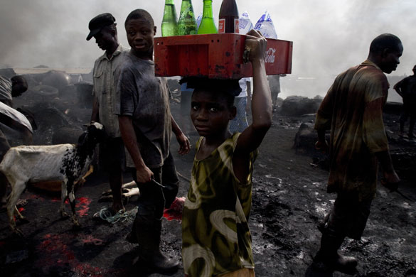Shell in the Niger Delta: A young girl sells drinks in the abbatoir of Port Harcourt, Nigeria