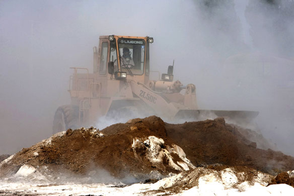 Chemical leak in China: A bulldozer is used to cover up a leaking chemical truck