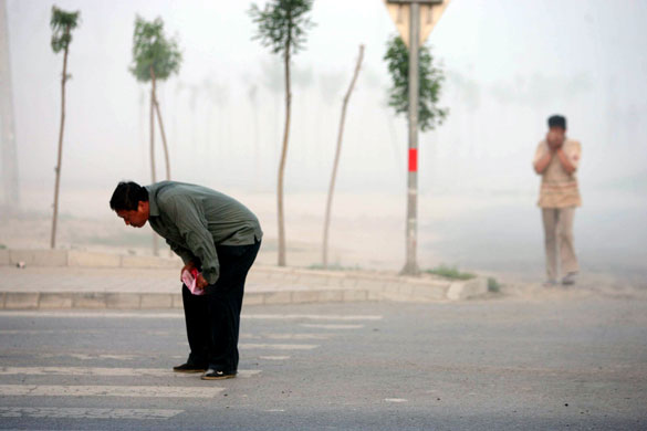 Chemical leak in China: A man retches as he walks past the truck