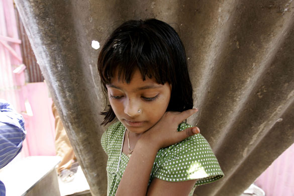 21 May 2009: Mumbai, India: Rubina Ali stands inside her house