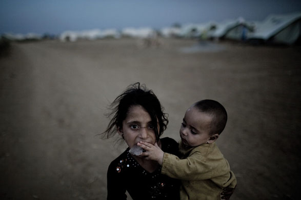 21 May 2009: Swabi, Pakistan: A young girl and her brother at the Chota Lahore camp