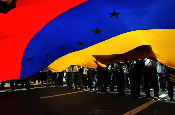 21 May 2009: Caracas, Venezuela: Students wave a national flag during a demonstration
