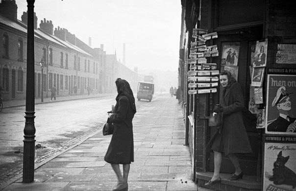 Week in Business: A woman waits for her friend to come out of a newsagents in Leicester, 1948