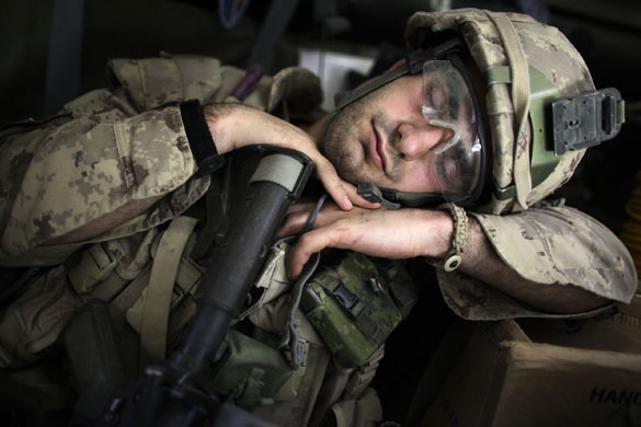 22 May 2009: Kandahar, Afghanistan: A Canadian soldier takes a nap