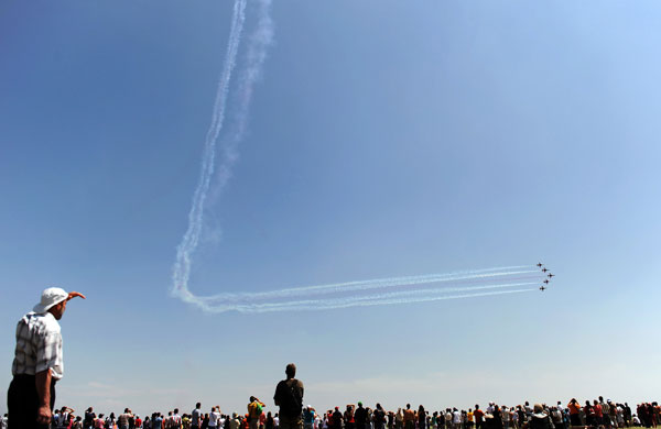24 hours in pictures: Plovdiv, Turkey: People watch the Turkish Air Force aerobatic team perfrom
