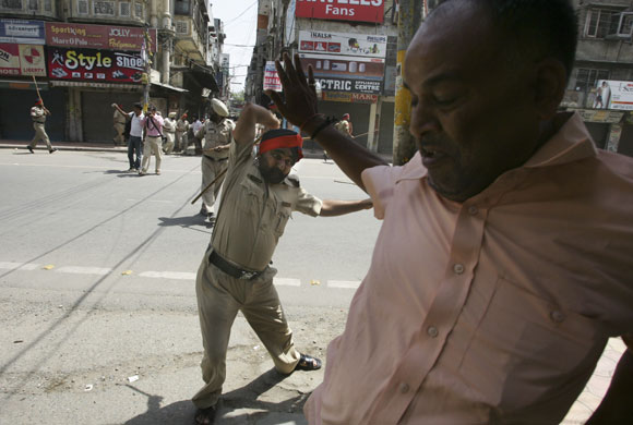 24 hours: An Indian police officer beats a protester in  Amritsar