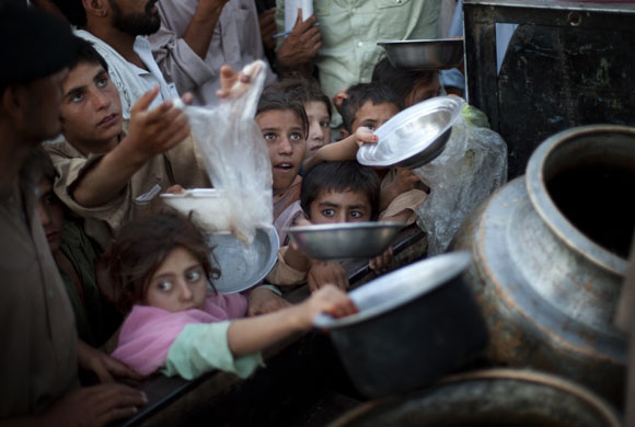 26 May 2009: Peshawar, Pakistan: Displaced children struggle to get their ration