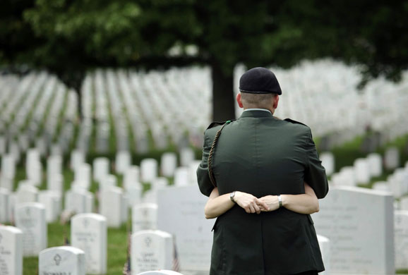 26 May 2009: Arlington, US: A soldier is hugged at the Arlington National Cemetery