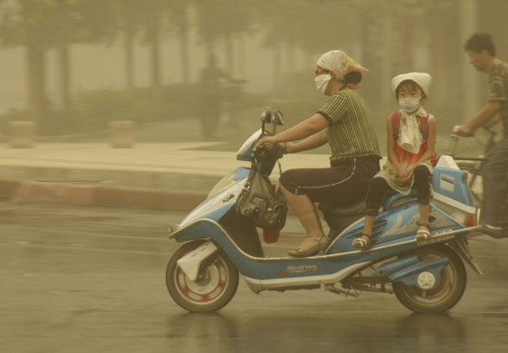 26 May 2009: Turpan, China: People during a sandstorm