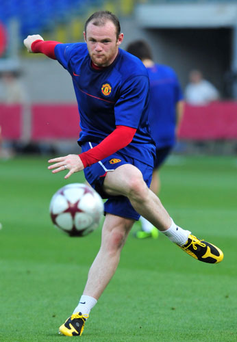 Training sessions: Wayne Rooney strikes the ball