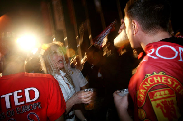Training sessions: Manchester United fans enjoy a beer in an open air pub 