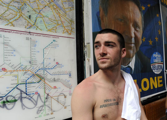 Countdown to kickoff: Manchester United fan Owen McEwan waits at a bus stop
