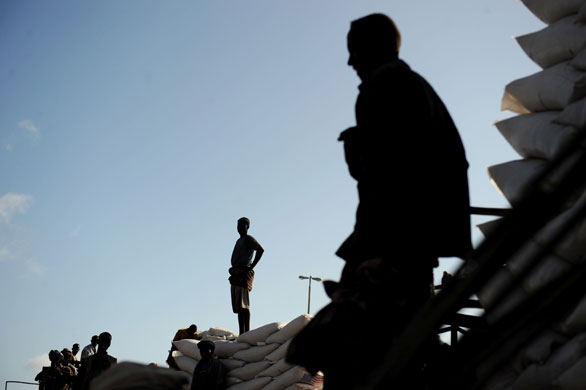 24 hours in pictures: Somali dock workers stand on trucks loaded with sacks of food aid