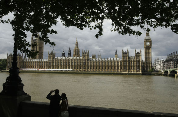 Week in business: A man takes a picture as clouds gather over the Palace of Westminster.