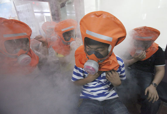 28 May 2009: Seoul, South Korea: Elementary school students wearing gas masks