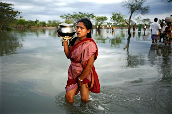 29 May 2009: Satkhira, Bangladesh: People wade in floodwaters