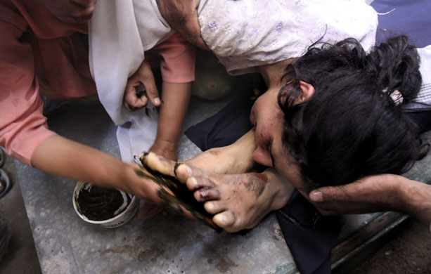 29 May 2009: Pampore, India: Sisters of Shifyat Ahmed during his funeral procession