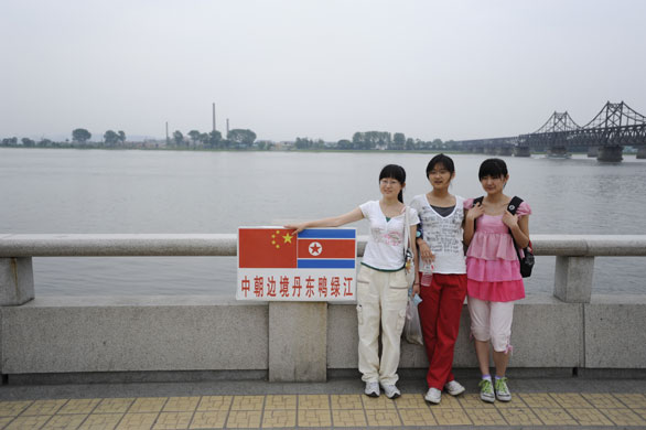North Korea Border: Chinese tourists at the Yalu river in Dandong, China