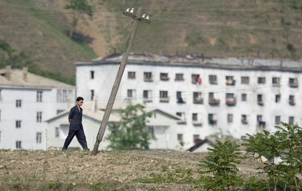 North Korea Border: A man walks along the riverside of the Yalu river, China