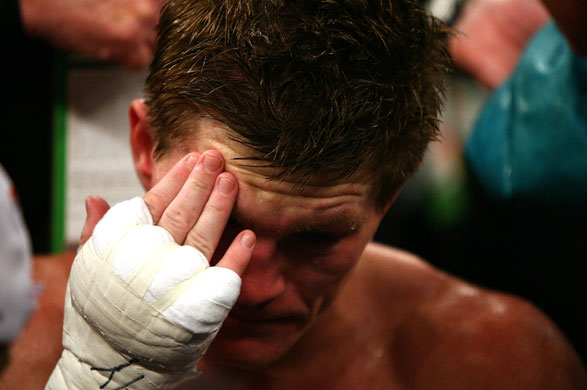 Hatton and Pacquiao: Ricky Hatton holds his head after he was knocked out