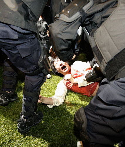 3 May 2009: Seoul: Policemen detain a protester at an anti-government rally