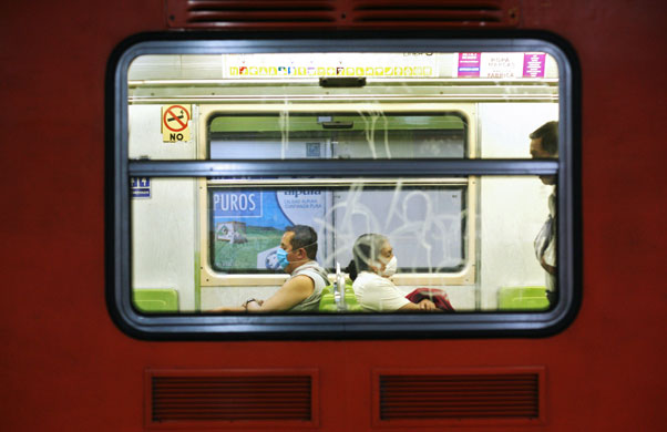 3 May 2009: Mexico City, Mexico: People wearing surgical masks on the subway