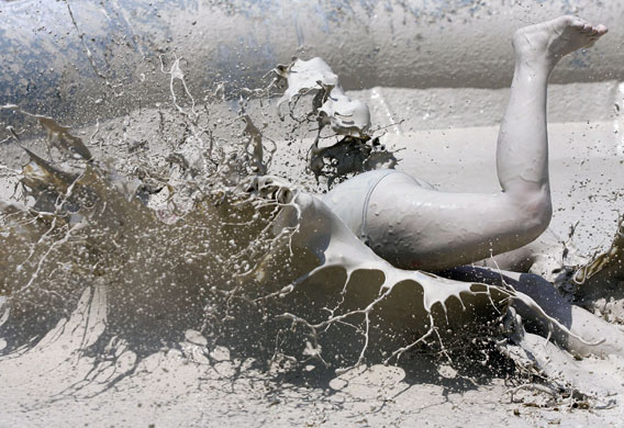 3 May 2009: Wuhan, China: Two women wrestle in a mud pool
